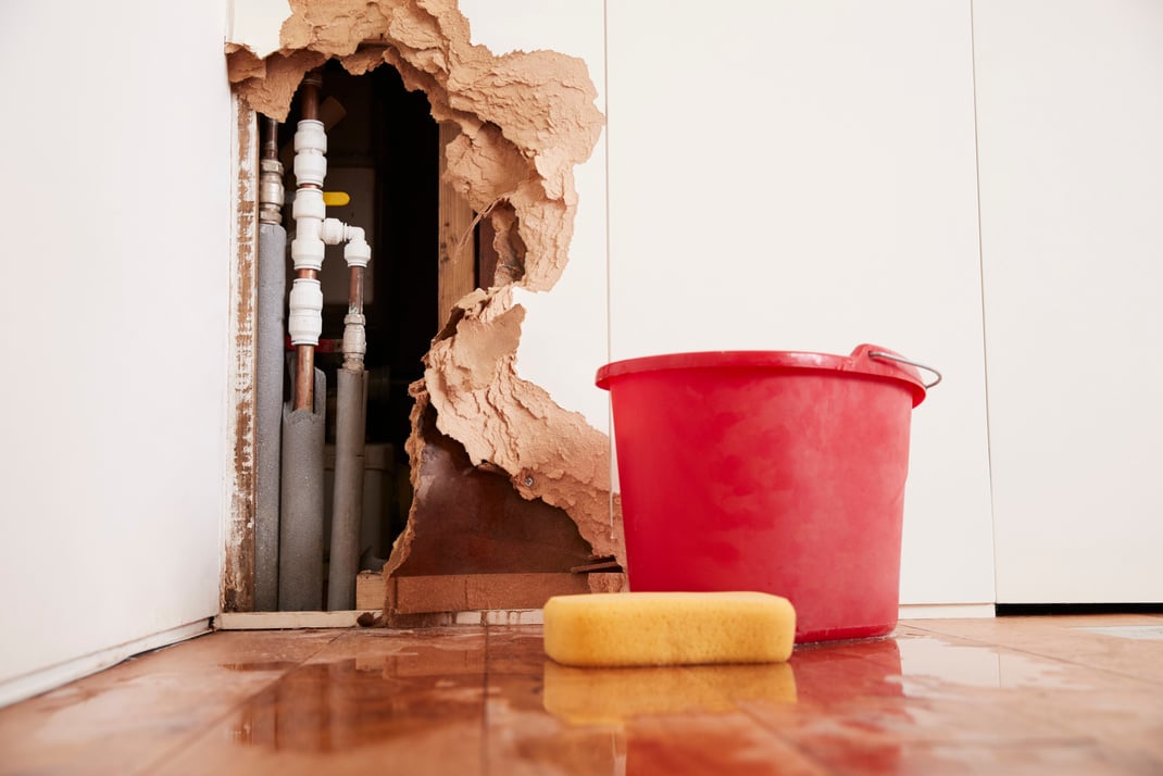 Damaged Wall Exposed Burst Water Pipes Sponge And Bucket